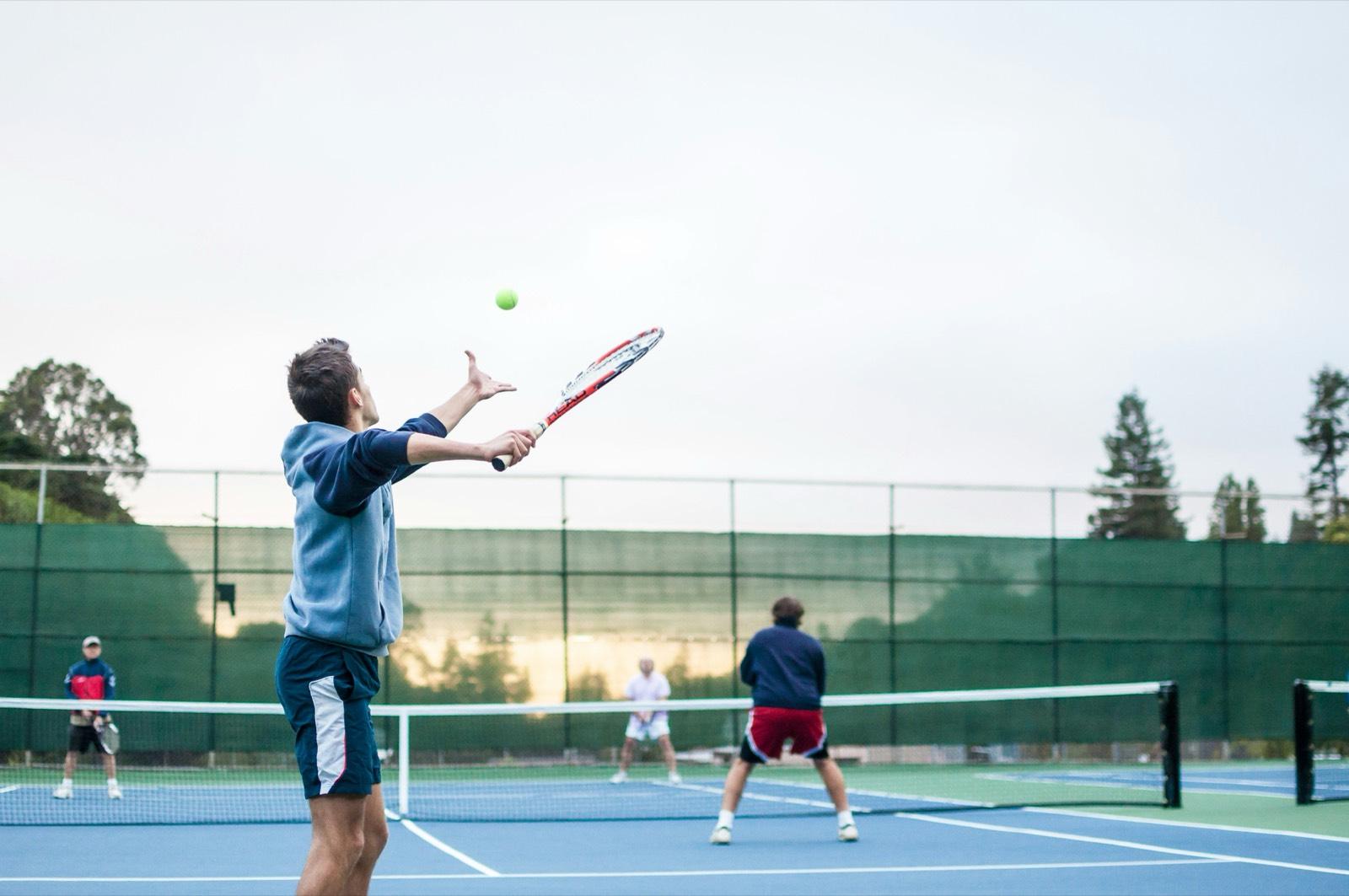 Players and a coach on court during a group session